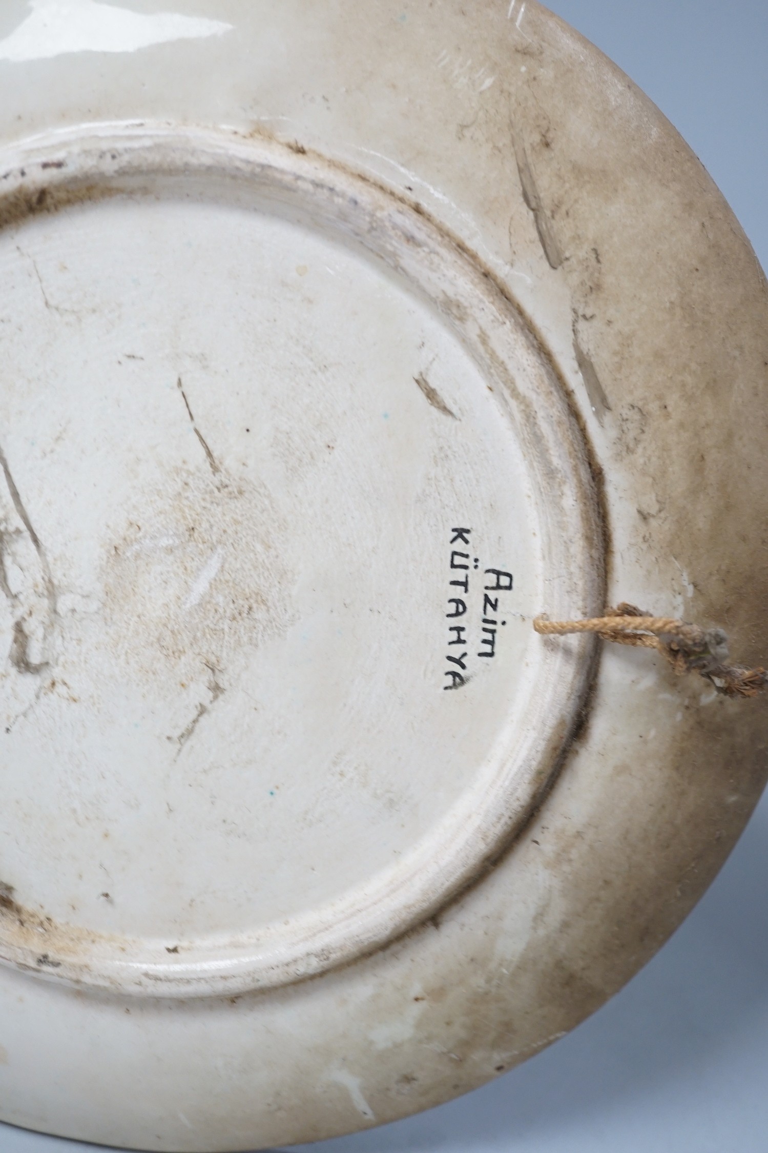 A Kütahya pottery dish, the back marked Azim Kütahya, diameter 31cm